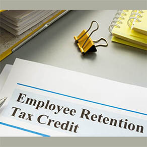 Employee retention tax credit papers and folder.