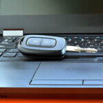 Car key resting on laptop keyboard