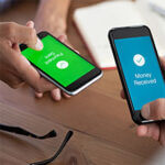 Photo of two cellular phones each being held by two different people, one with the word "payment sent" and the other with the words "payment received"