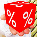 Man holds cubes with percent sign