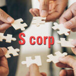 Hands holding pieces of a puzzle forming a circle