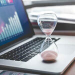 Open laptop with an hourglass on it