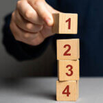 Wooden blocks with the number 1 2 3 4 being stacked on top of each other.