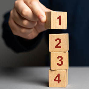 Wooden blocks with the number 1 2 3 4 being stacked on top of each other.