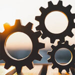 Close up of gears with sunset in the background