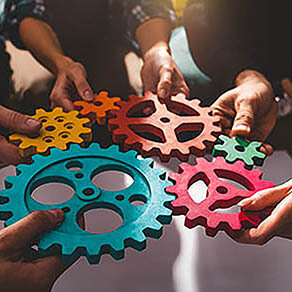 People work together and combine pieces of gears