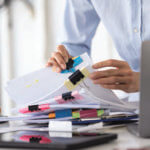 Business man's hands looking through business documents