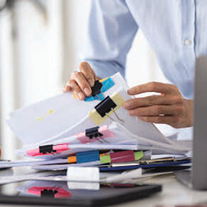 Business man's hands looking through business documents