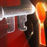 keyhole with light coming from it and old key going into it