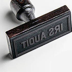 Rubber stamping that says 'IRS Audit'.