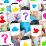 People standing together covering their faces with images of social media icons