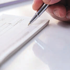 Close up of someone writing out a check