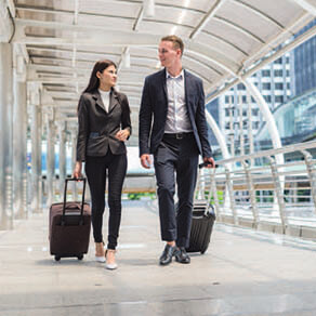 Man and woman walking through airport together