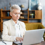 Businesses woman at table with a laptop