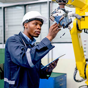 Man inspecting a piece of equipment in a warehouse