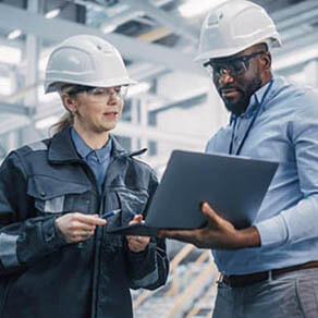 Technicians talking in a meeting in a factory.