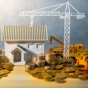 House,,Crane,And,Construction,Truck,Models,With,Gold,Coins,Spilling