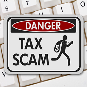 Tax scam danger sign, A black and white danger sign with text Tax Scam and theft icon on a keyboard