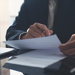 Man's hand Signing contract, business documents