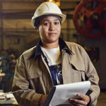 Waist up portrait of female worker holding clipboard while supervising production at factory, copy space