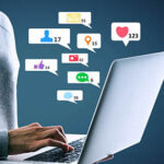 Close up of hacker hand using laptop with creative social media icons on abstract background. Like, network, technology and communication concept