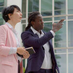 Man pointing to something while woman looks on