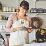 Waitress/ store owner taking an order on a tablet