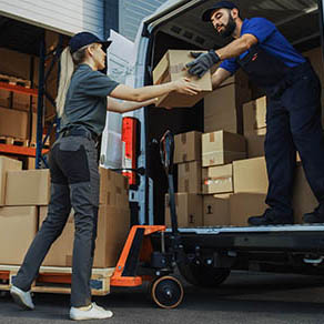 Team of Workers using a loading boxes into a delivery van