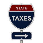 Road sign that says "State Taxes" with arrow pointing right