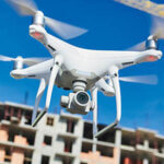 Drone operated by construction worker on building site
