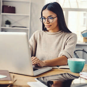 Woman working from a home office on her laptop