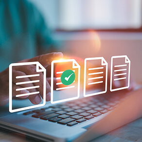 Laptop keyboard with graphic overlay over four documents