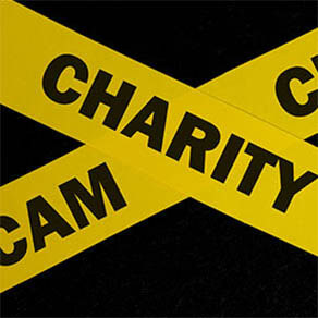 caution and warning concept. Yellow barricade tape with word in dark black background