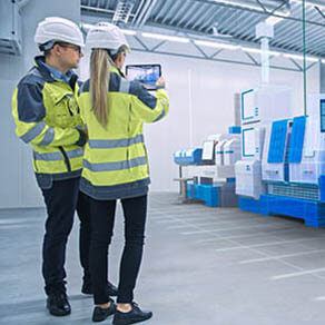 Two people observing machinery