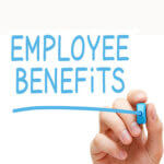 A hand writing the words "Employee Benefits" with a blue marker