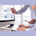 Team of consulting auditors auditing the financial report data of the company (balance sheet, income statement) on computer screen with business charts, fintech