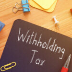 Withholding Tax is shown on the conceptual business photo