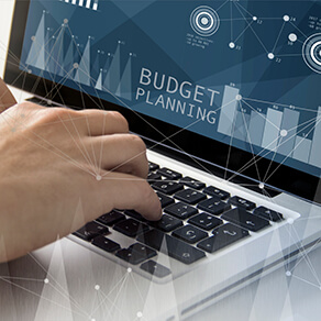 Someone typing on a laptop with the words 