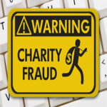 Warning sign for charity fraud with man silhouette running away with money bag