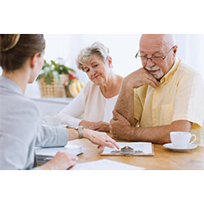 Older couple looking over papers with adviser