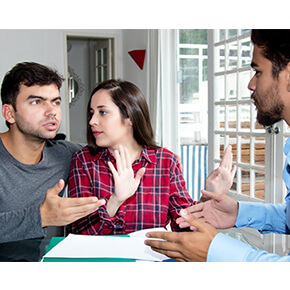 couple talking with agent looking upset