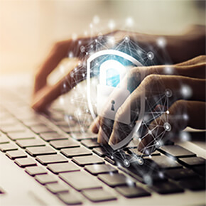 Hands typing on keyboard with cyber security protection lock symbol