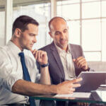 Two business men looking at a tablet