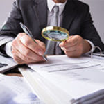 Man with magnifying glass investigating Innocent Spouse Rules