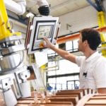 Labor technician looking and touching a technology computer