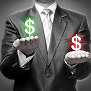 Man holding a dollar sign in red and a dollar sign in green