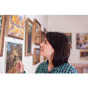Woman looking at photos on a wall