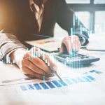 Man working on a graph using a calculator