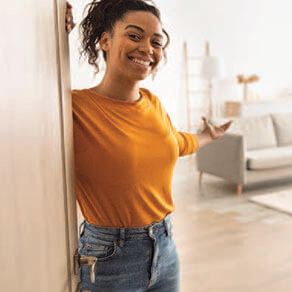 Woman in doorway showing off her room