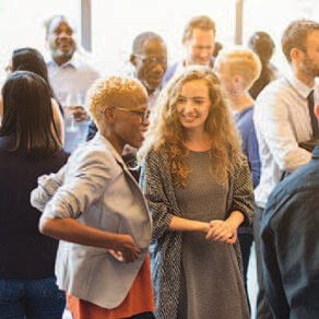 A group of people mingling at a professional event
